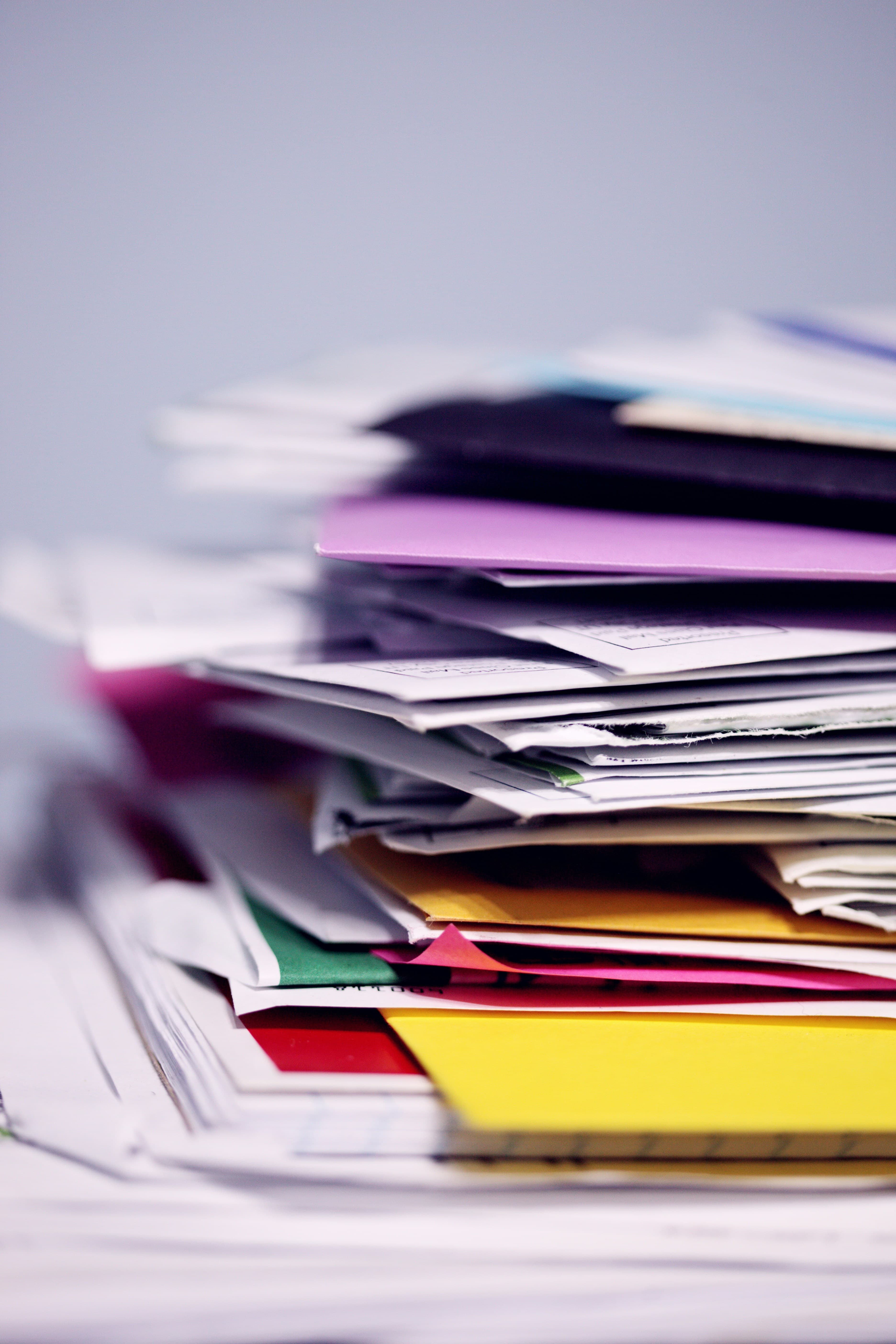 A stack of colorful folders and papers